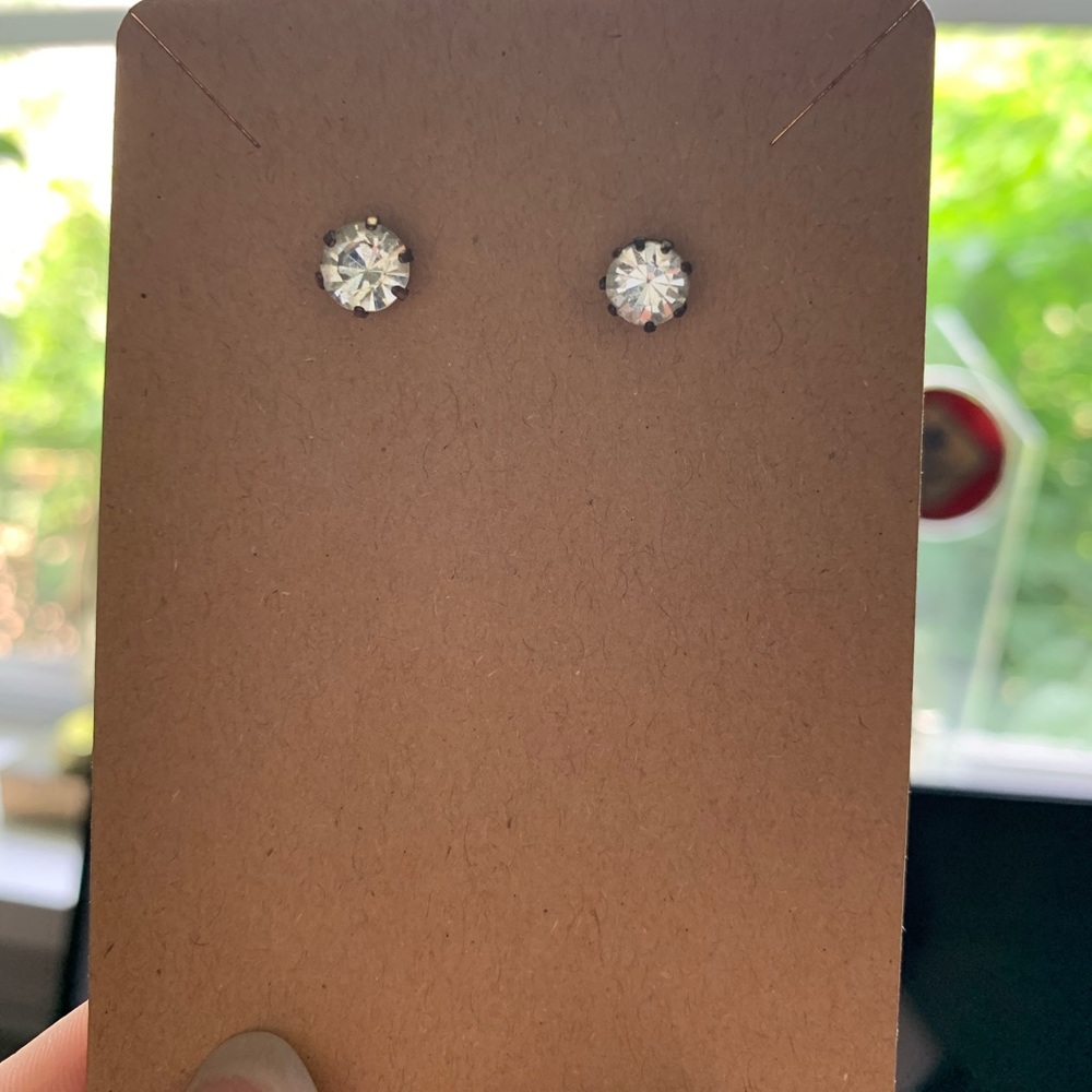 Silver diamond studs. With plastic backs.